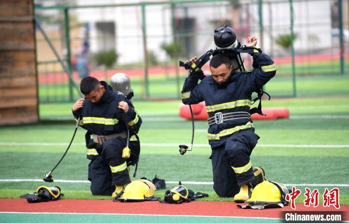 新消防員進(jìn)行穿戴空呼器展示。　劉忠俊 攝